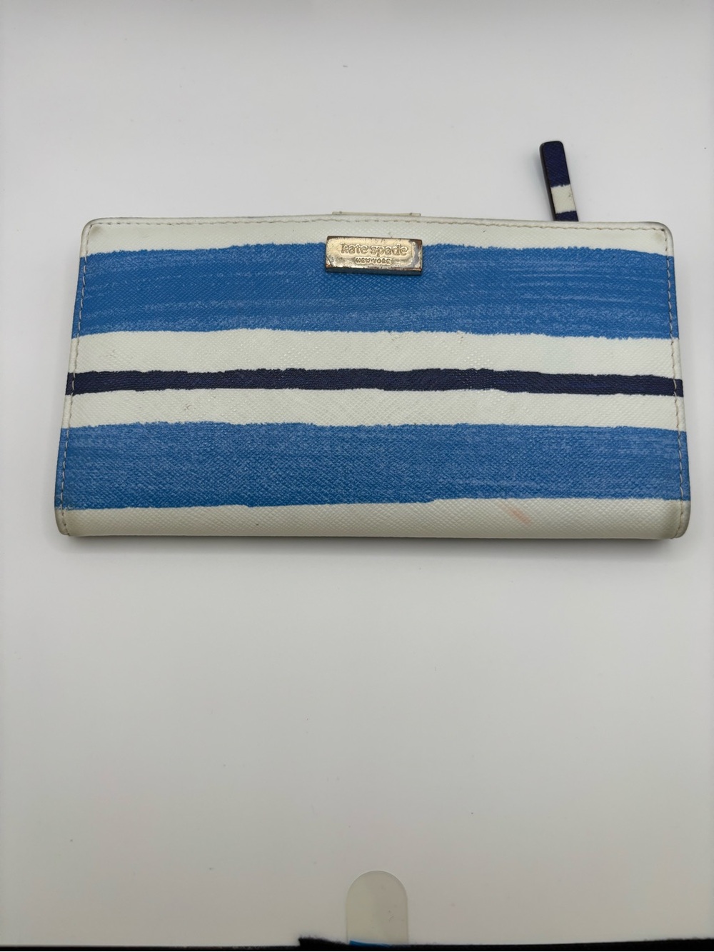 Kate Spade New York Blue, Navy & White Striped Wallet with Gold Logo showing wea